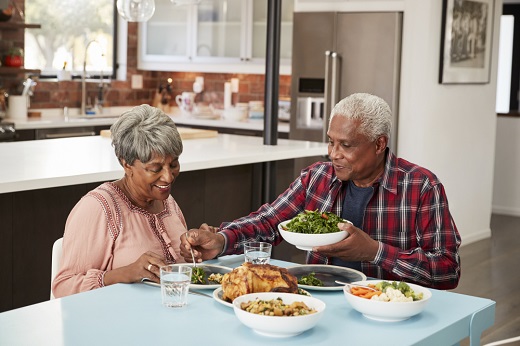 Elderly couple enjoying a meal together.