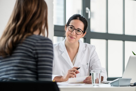 Doctor consulting with a patient in office.